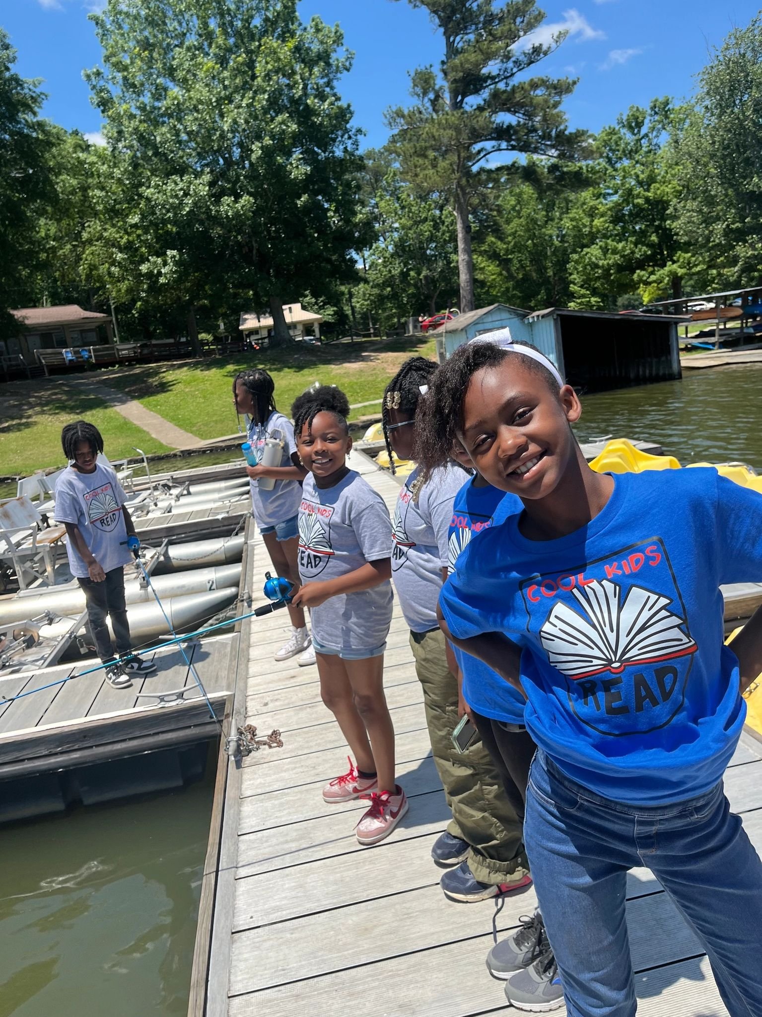 Cool Kids Read members smiling on a lake trip